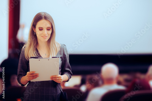 Obraz na plátně Happy Woman Holding a Clipboard Attending a Conference