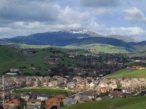 Homes in San Ramon between rolling hills of East Bay and snowy Mt Diablo after a winter storm photo