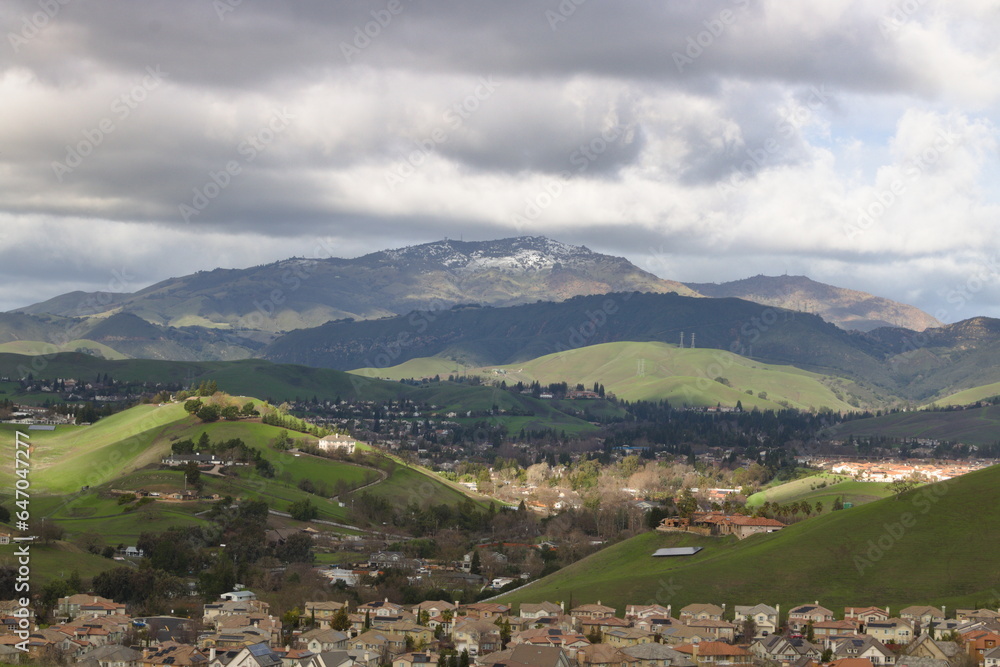 Homes in San Ramon between rolling hills of East Bay and snowy Mt Diablo after a winter storm