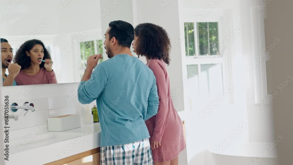 Bathroom, mirror and talking couple brush teeth with tooth whitening toothpaste, toothbrush and chat about morning routine. Communication, home and marriage people consulting about oral gum hygiene Bathroom, mirror and talking couple brush teeth with tooth whitening toothpaste, toothbrush and chat about morning routine. Communication, home and marriage people consulting about oral gum hygiene