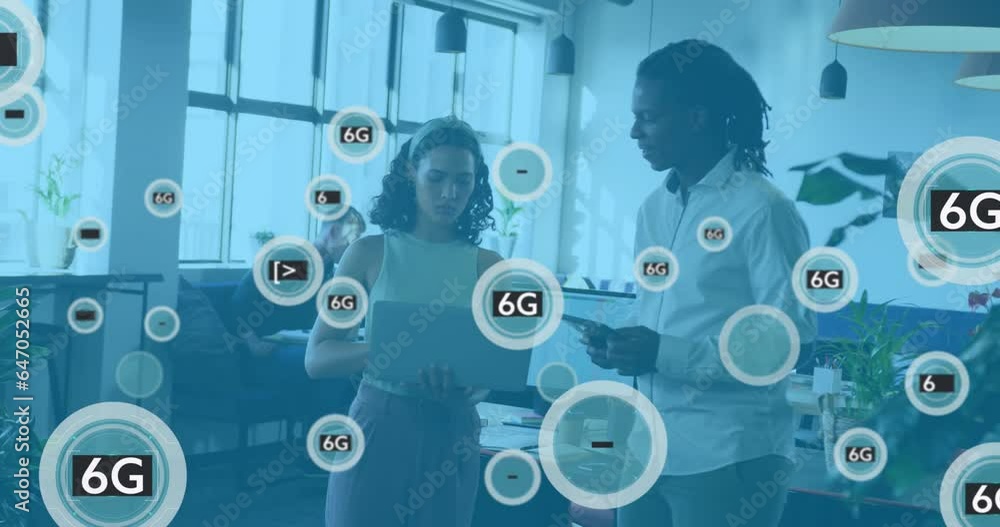 Animation of 6g text in circles over diverse coworkers standing and discussing reports on laptop Animation of 6g text in circles over diverse coworkers standing and discussing reports on laptop