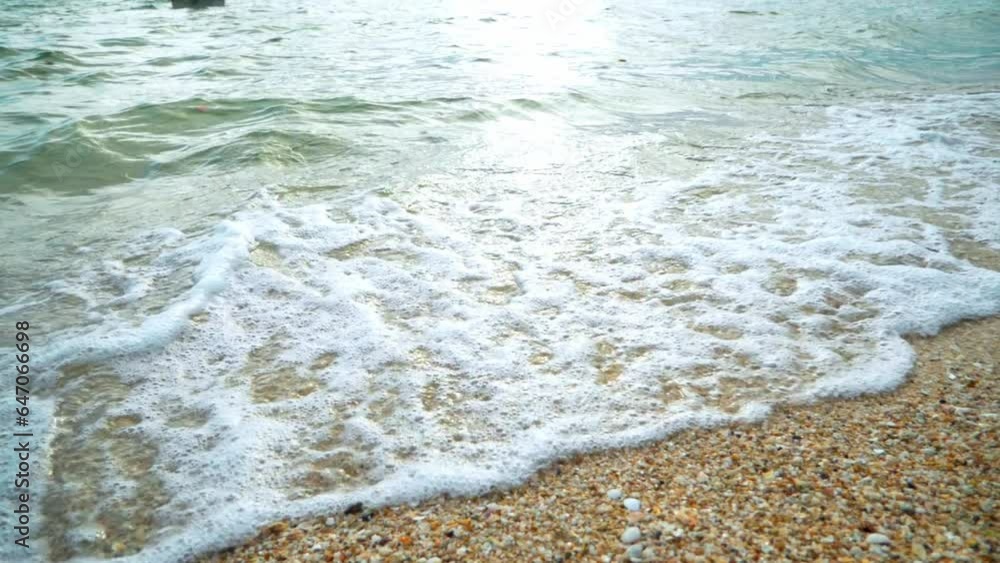 Beautiful beach with waves reaching the shore of a white sand beach on a tropical during a sunset. Slow Motion Beautiful beach with waves reaching the shore of a white sand beach on a tropical during a sunset. Slow Motion