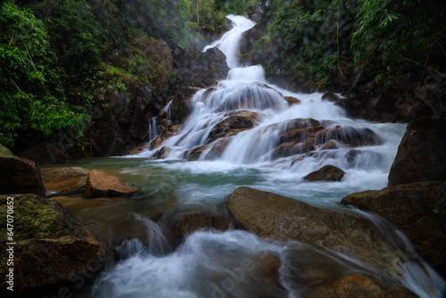 Fototapeta Naklejka Na Ścianę i Meble -  Krating waterfall in the rainy season and refreshing greenery forest in the national park of Khao Khitchakut Chanthaburi province Thailand, wide angle shot, water drop in front