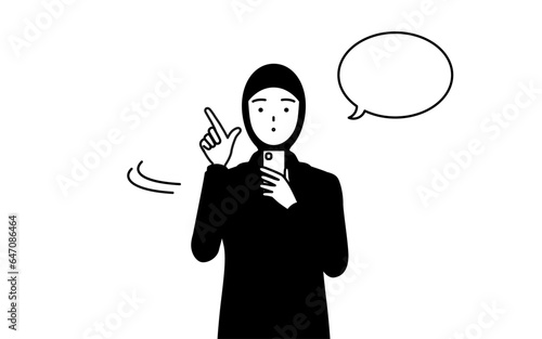 スマホを操作するイスラムの女性