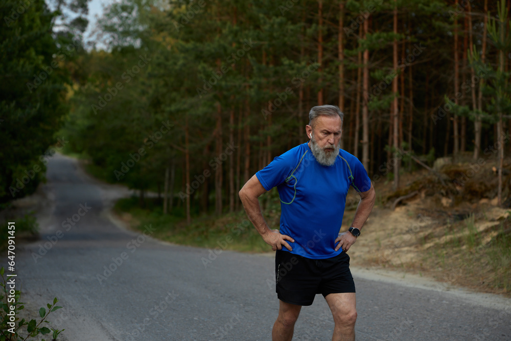 Tired retired sportsman breathing hard after jogging exercise