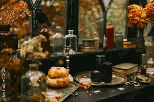 Halloween party decor in gloomy dark colors with the table is set © klavdiyav