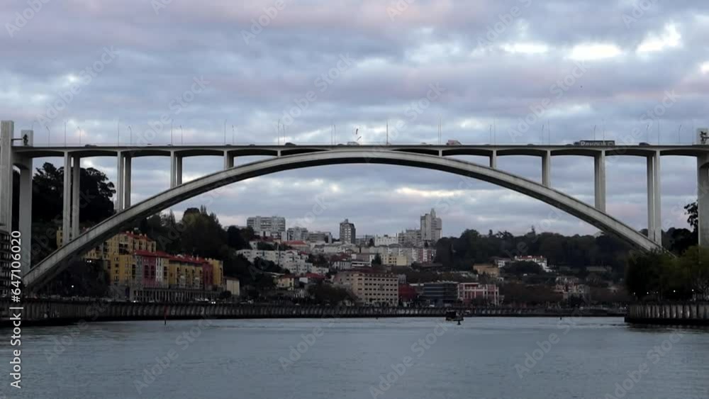 Arrabida Bridge with vehicular flow connecting city of Porto, seen from the Douro river Arrabida Bridge with vehicular flow connecting city of Porto, seen from the Douro river
