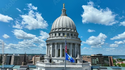 Minnesota state flag waving on capitol building in front of dome. Aerial static shot with cinematic flags. Beautiful summer day. photo
