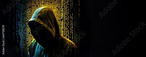 Coder in a hoodie, face unrecognizable. Hacker, computer security. Cyber security. Identity theft. Code running in green, yellow glitch. Anonymity in web. Dark web, phishing, cyber attack. Concept. photo