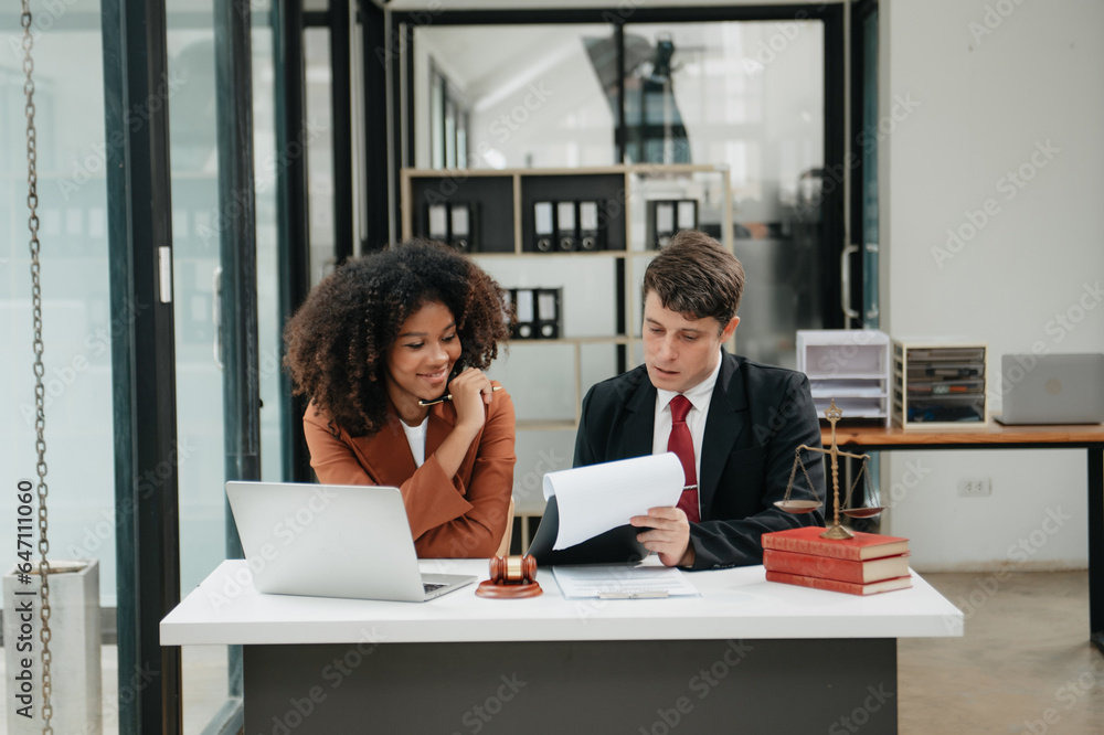 Business and lawyers discussing contract papers with brass scale on desk in office. Law, legal services, advice, justice and law concept .. Business and lawyers discussing contract papers with brass scale on desk in office. Law, legal services, advice, justice and law concept ..