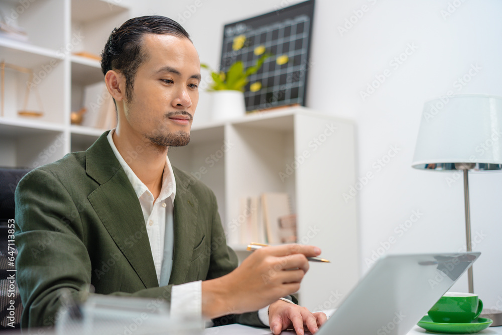 Handsome young ambitious developer working alone at the office Handsome young ambitious developer working alone at the office