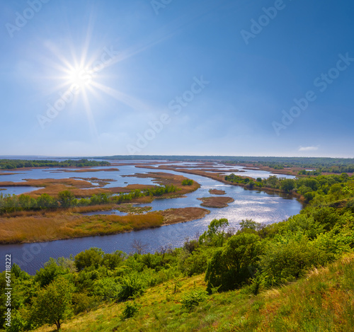 calm river delta flow among prairie under a sparkle sun
