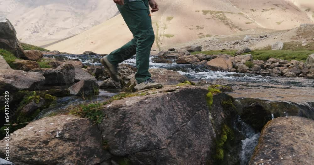Mountain stream, stream crossing, feet in sneakers, slow motion. Arashan. Legs of man in sneakers, crossing stream over stones. Cinematic. Cinematic ecological amazing nature. Concept of peaceful life Mountain stream, stream crossing, feet in sneakers, slow motion. Arashan. Legs of man in sneakers, crossing stream over stones. Cinematic. Cinematic ecological amazing nature. Concept of peaceful life