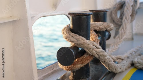 Close up of nautical rope with sailing knot on the bitts for boating and mooring vessel.  photo
