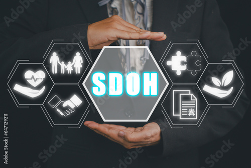 SDOH, Social Determinants Of Health concept, Businesswoman hand holding Social Determinants Of Health icon on virtual screen.