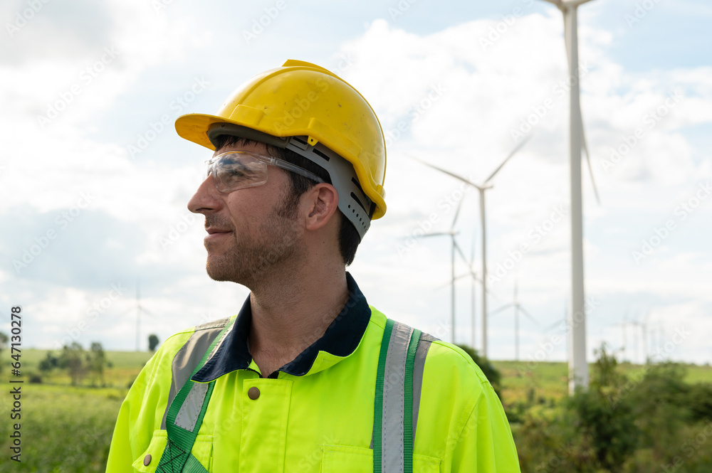 Portrait of smart engineer with protective helmet at electrical turbines field Portrait of smart engineer with protective helmet at electrical turbines field