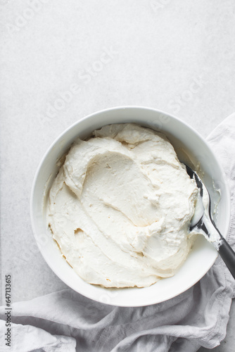 Greek yogurt in a white bowl, process of making Greek yogurt, strained yogurt in ceramic white bowl