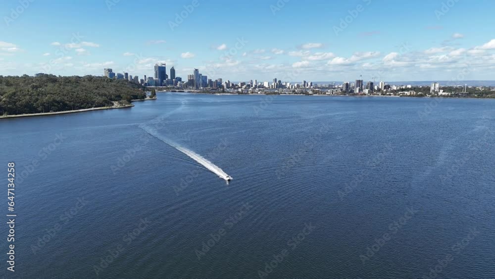 Speed boat cruising past drone on the Swan river in Perth, Western Australia on clear sky day Speed boat cruising past drone on the Swan river in Perth, Western Australia on clear sky day