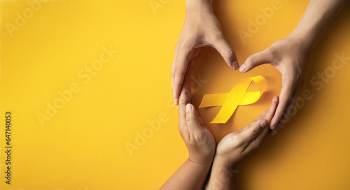 Quadro su tela yellow ribbon in hands sick person suffering from cancer make heart symbol, world cancer day, healthcare and medicine backdrop, suicide prevention, children health care