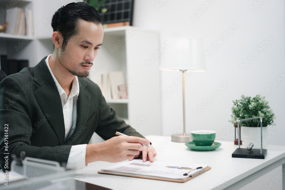 Handsome young ambitious developer working alone at the office Handsome young ambitious developer working alone at the office