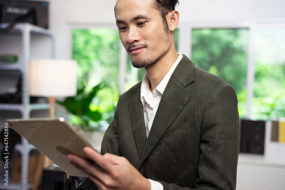 Businessman using digital tablet at desk in office
Businessman using digital tablet at desk in office
