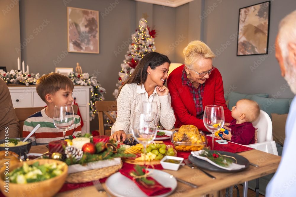 Happy multi-generation family gathered at home for Christmas dinner