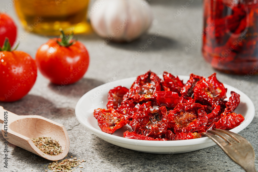 A bowl of homemade sun-dried tomatoes on the kitchen table. Studio shot. A bowl of homemade sun-dried tomatoes on the kitchen table. Studio shot.