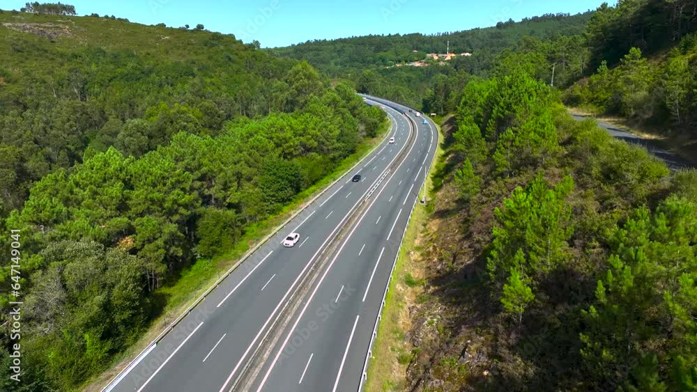 Traffic Over Asphalt Road Along Forested Valleys Near Padron, Rois, A Coruna, Spain. Aerial Shot Traffic Over Asphalt Road Along Forested Valleys Near Padron, Rois, A Coruna, Spain. Aerial Shot