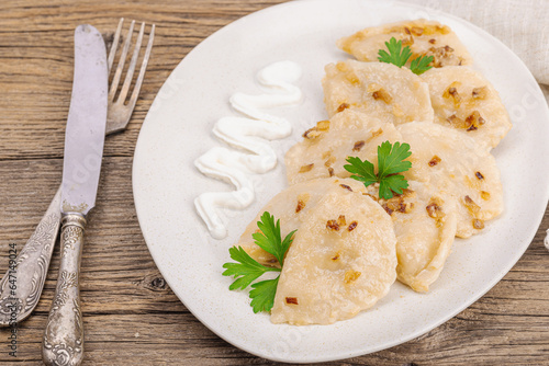 Dumplings, filled with cabbage. Fried onion, fresh sour cream. Traditional Ukrainian dish
