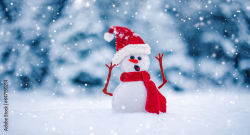 Little knitted snowman on the white snow on blue background. © candy1812