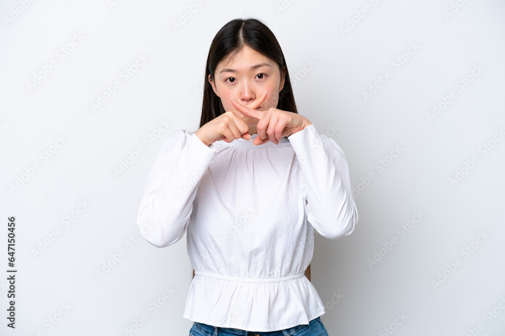 Young Chinese woman isolated on white background showing a sign of silence gesture Young Chinese woman isolated on white background showing a sign of silence gesture