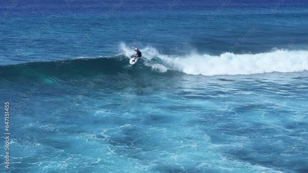 Aerial shot of tourists surfing waves in the sea in the Maldives Aerial shot of tourists surfing waves in the sea in the Maldives