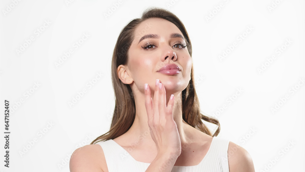 Beautiful young woman with clean fresh skin touching her own face. Facial treatment. Cosmetology, beauty and spa. Beautiful young woman with clean fresh skin touching her own face. Facial treatment. Cosmetology, beauty and spa.