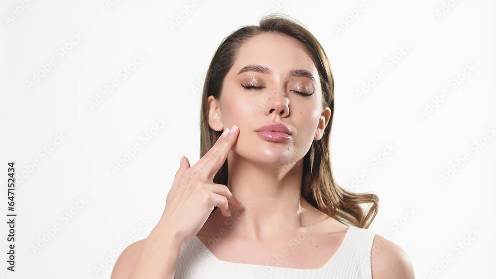 Beautiful young woman with clean fresh skin touching her own face. Facial treatment. Cosmetology, beauty and spa. Beautiful young woman with clean fresh skin touching her own face. Facial treatment. Cosmetology, beauty and spa.
