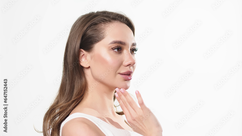 Beautiful young woman with clean fresh skin touching her own face. Facial treatment. Cosmetology, beauty and spa. Beautiful young woman with clean fresh skin touching her own face. Facial treatment. Cosmetology, beauty and spa.