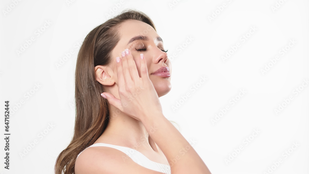 Beautiful young woman with clean fresh skin touching her own face. Facial treatment. Cosmetology, beauty and spa. Beautiful young woman with clean fresh skin touching her own face. Facial treatment. Cosmetology, beauty and spa.