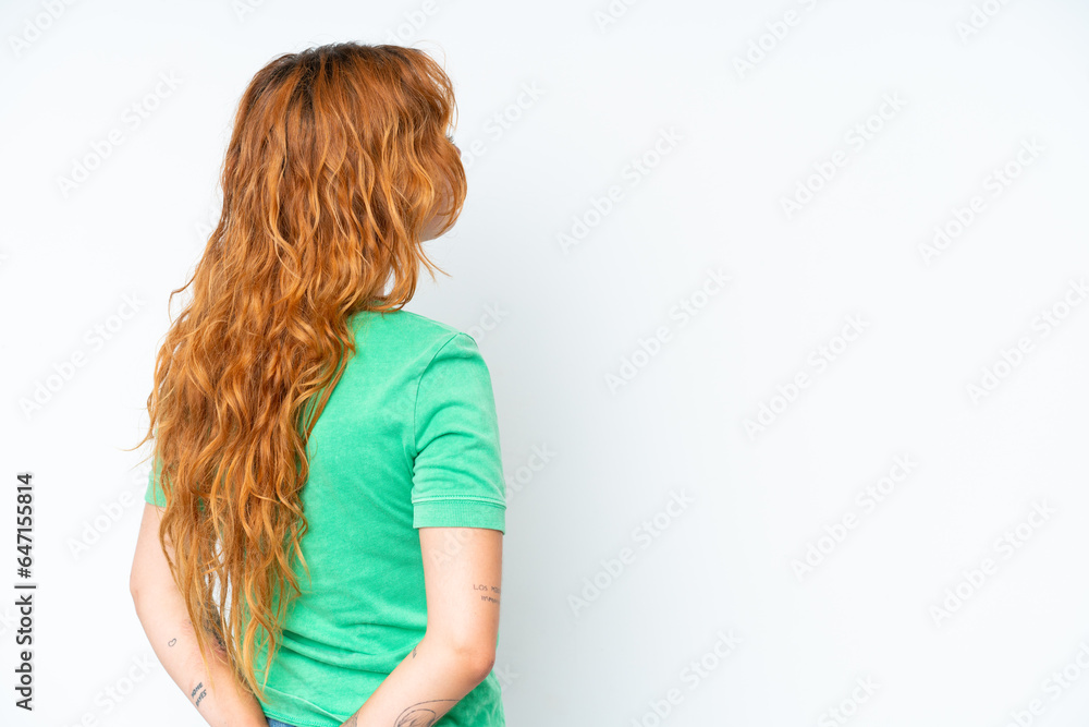 Young caucasian woman isolated on white background in back position and looking back Young caucasian woman isolated on white background in back position and looking back