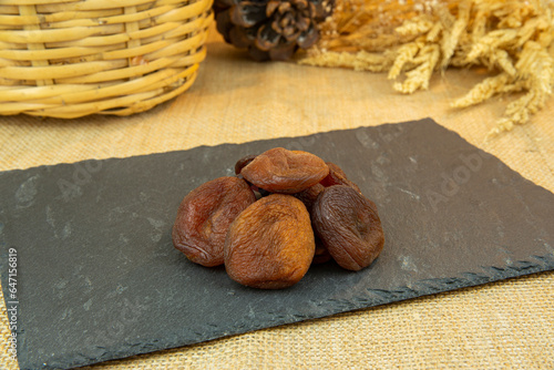Sun dried apricot on rock plate
