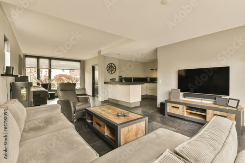 a living room with couches and a flat screen tv mounted on the wall in the room is very modern