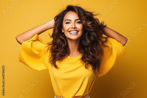 Excited young asian woman with raised hands celebrating success.