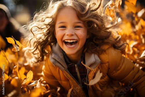 Young girl with hair in braids playing in the leaves.