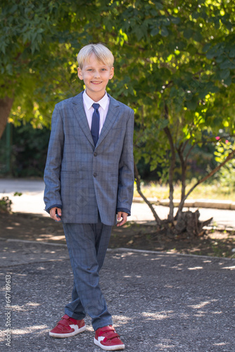 Happy schoolboy in plaid suit © Andrey_Arkusha