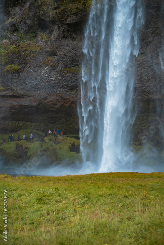 Kvernufoss a 30-meters high waterfall accessible via a rugged hiking trail in Iceland photo