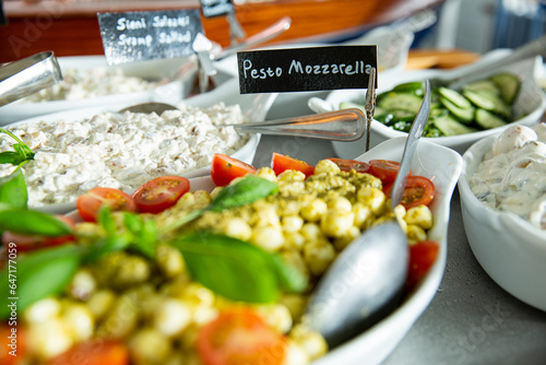 Cafe lunch buffet with pesto mozzarella salad. Healthy dinner in restaurant buffet menu