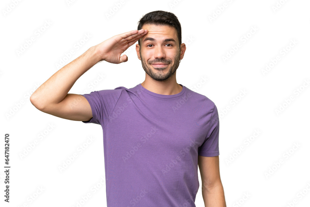 Young handsome caucasian man over isolated background saluting with hand with happy expression Young handsome caucasian man over isolated background saluting with hand with happy expression