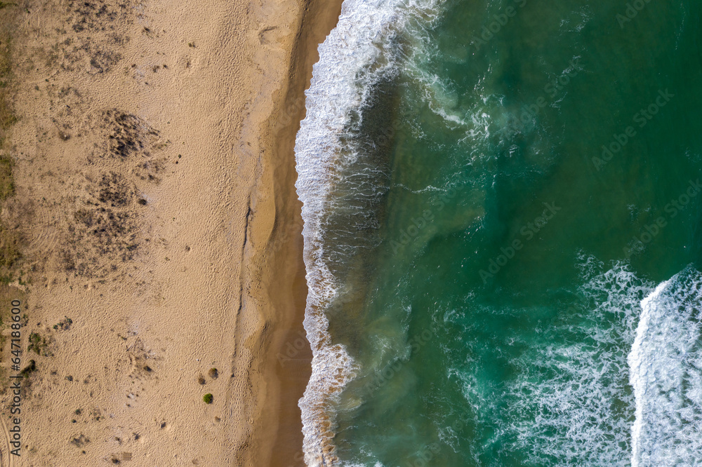 Aerial view of a remote sandy beach and sea waves Aerial view of a remote sandy beach and sea waves