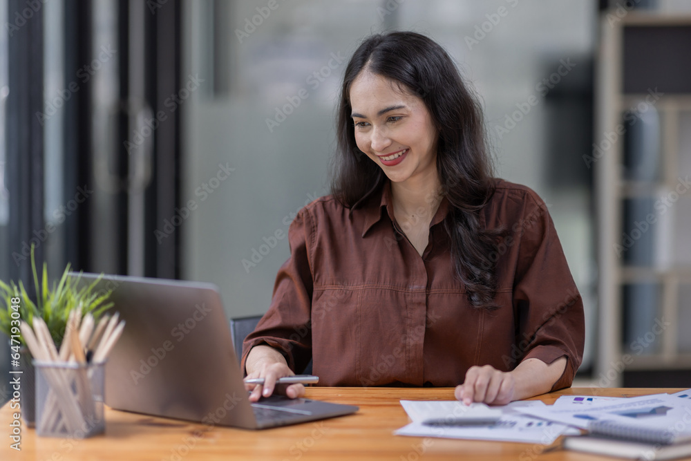 Young attractive business asian woman checking searching document her project with laptop computer in the office room. Young attractive business asian woman checking searching document her project with laptop computer in the office room.