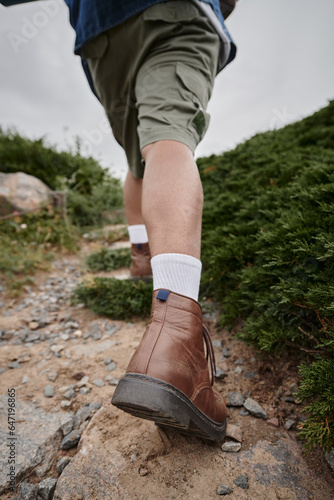tranquil nature, cropped view of hiker walking in brown boots with white socks, adventure, traveler