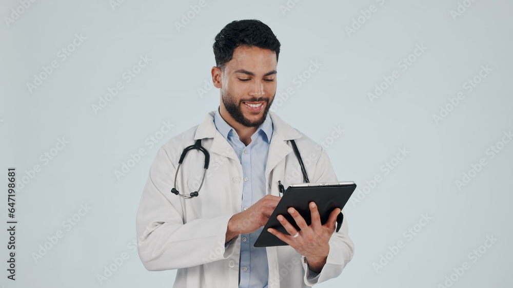 Doctor, man and tablet for healthcare service, social media and clinic software, internet scroll or research in studio. Happy medical worker on digital technology or hospital app on white background Doctor, man and tablet for healthcare service, social media and clinic software, internet scroll or research in studio. Happy medical worker on digital technology or hospital app on white background