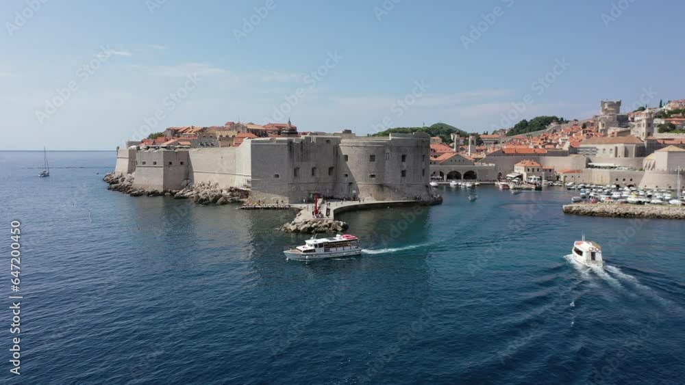 Dubrovnik old town. Aerial view of historic city of Dubrovnik in Croatia. Famous tourist attraction in the Mediterranean. Summer. Old port by the Adriatic sea. Dubrovnik old town. Aerial view of historic city of Dubrovnik in Croatia. Famous tourist attraction in the Mediterranean. Summer. Old port by the Adriatic sea.